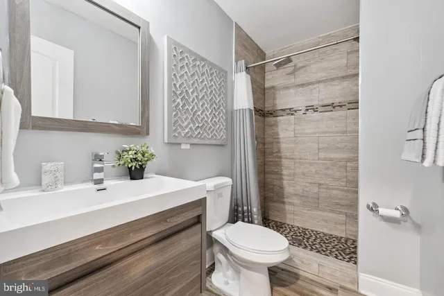 a bathroom with a sink toilet and shower