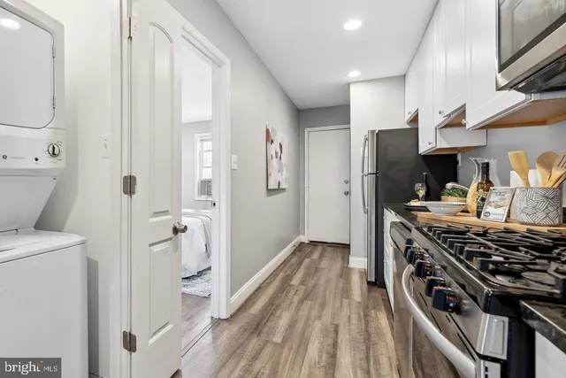 a kitchen with stainless steel appliances a stove a refrigerator and cabinets