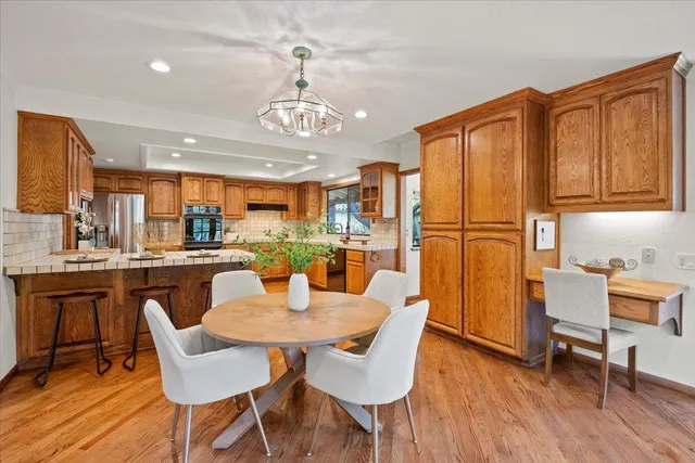 a living room with furniture flowers and a fireplace