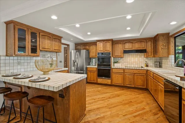 a living room with furniture a fireplace and a chandelier