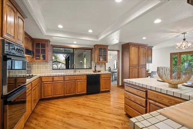 a dining room with furniture a floor to ceiling window and wooden floor
