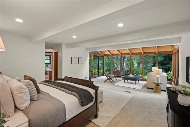 a bathroom with a tub sink and mirror
