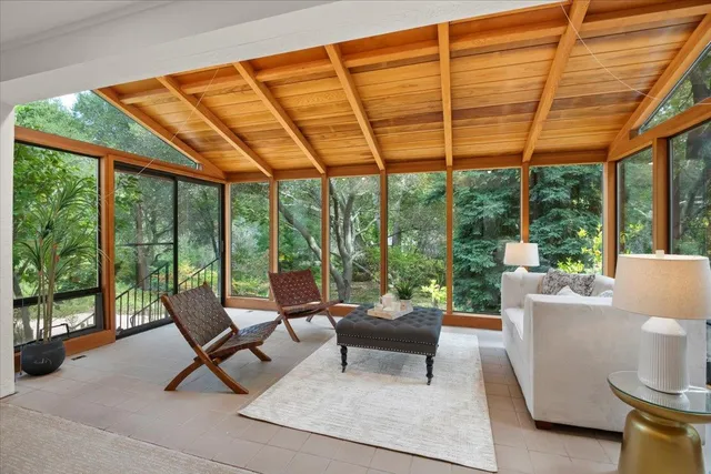 a bedroom with two beds and a large window