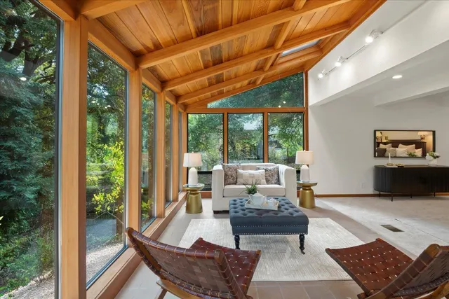 a bed sitting in a spacious bedroom next to a window
