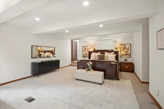 a bedroom with a bed and a potted plant