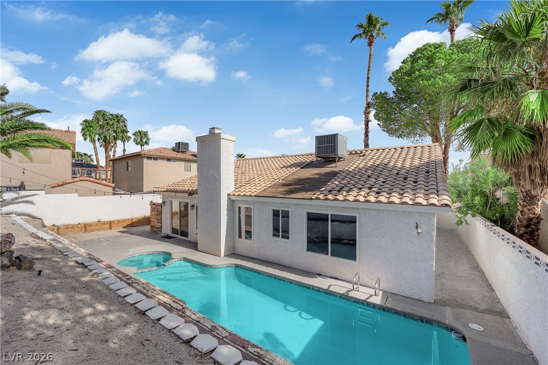 1433 Pathfinder Road Henderson, NV 89014 - Photo 30 of 35 An inviting backyard oasis features a shimmering private swimming pool beneath clear desert skies.