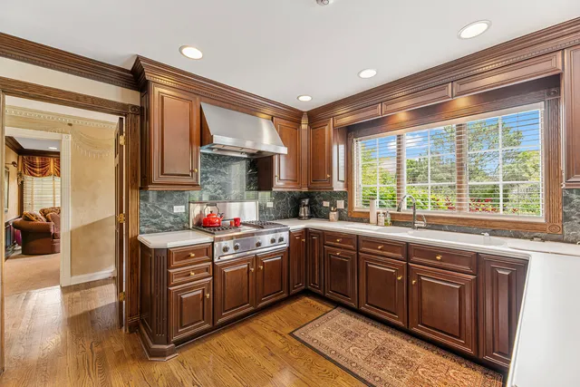 a kitchen with stainless steel appliances granite countertop a stove a sink dishwasher and a microwave oven with cabinets