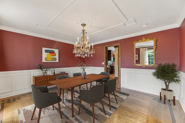 a view of a dining room with furniture and chandelier