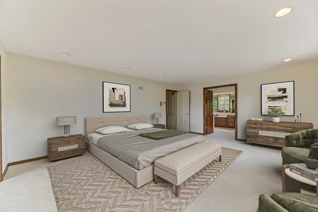 a spacious bedroom with a large bed and windows