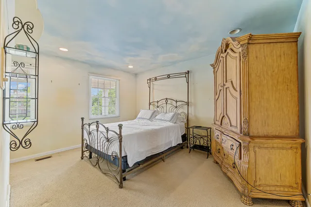 a bedroom with a bed and a couch