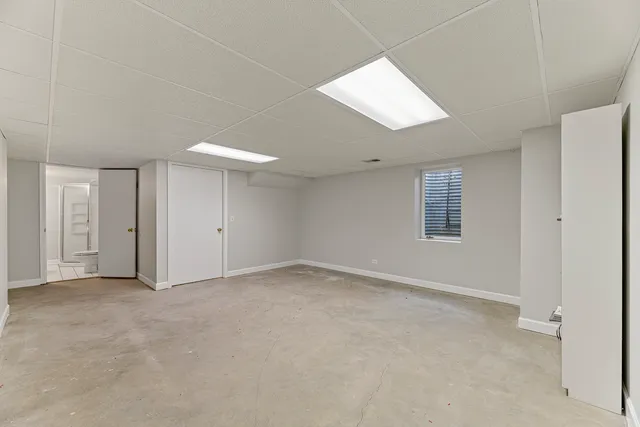 a front view of a house with a yard and potted plants