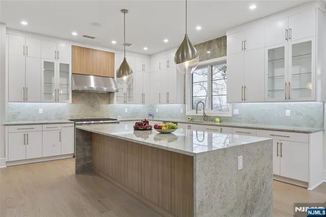 a bathroom with a double vanity sink mirror and shower