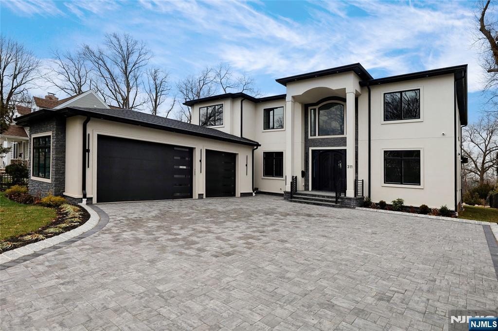 311 North Farview Avenue Paramus, NJ 07652 - Photo 2 of 50 a front view of a house with a yard and garage