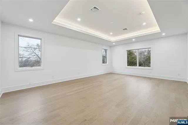 a view of an empty room with a kitchen