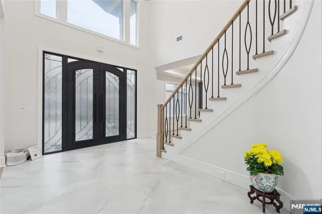 a large kitchen with granite countertop a large counter top a sink stainless steel appliances and cabinets