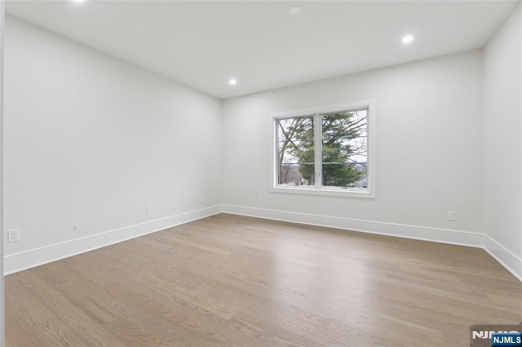 311 North Farview Avenue Paramus, NJ 07652 - Photo 35 of 50 an empty room with wooden floor and windows