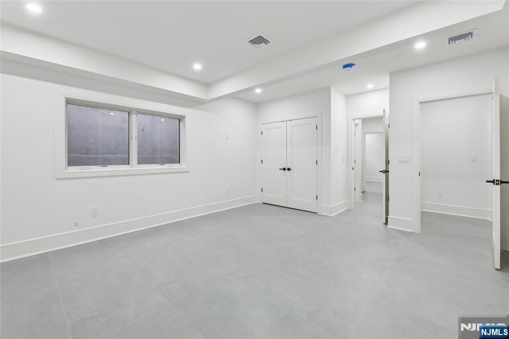 311 North Farview Avenue Paramus, NJ 07652 - Photo 46 of 50 an empty room with a cabinet and mirrors