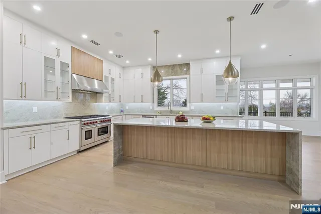 a large kitchen with stainless steel appliances kitchen island granite countertop a large counter top stainless steel appliances and cabinets