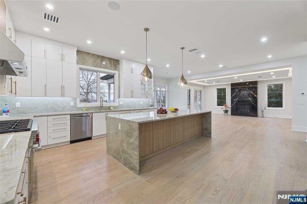 311 North Farview Avenue Paramus, NJ 07652 - Photo 7 of 50 a large kitchen with a large counter top a sink stainless steel appliances and cabinets