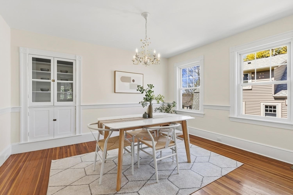 9 Governors Avenue, Unit 2 Winchester, MA 01890 - Photo 11 of 37 a dining room with chandelier and wooden floor