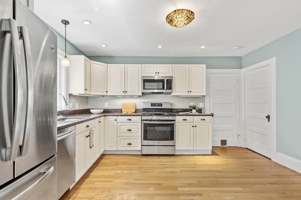 9 Governors Avenue, Unit 2 Winchester, MA 01890 - Photo 12 of 37 a kitchen with stainless steel appliances granite countertop a stove a sink and a refrigerator