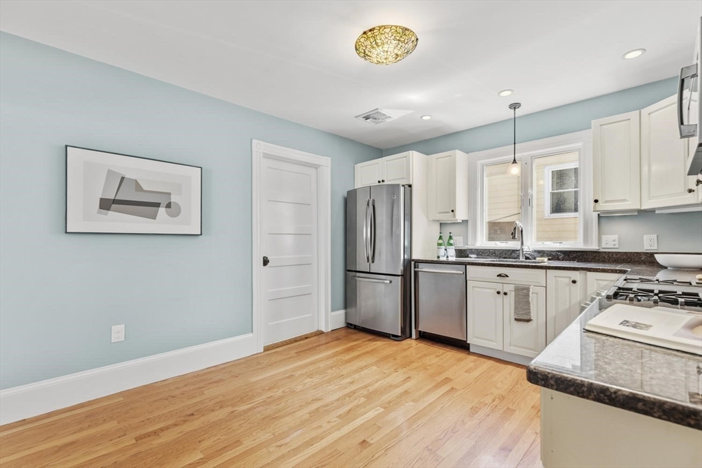 9 Governors Avenue, Unit 2 Winchester, MA 01890 - Photo 14 of 37 a kitchen with stainless steel appliances a refrigerator sink and stove
