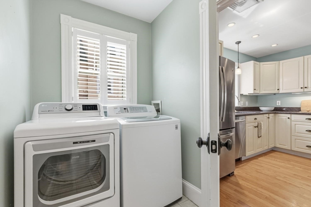 9 Governors Avenue, Unit 2 Winchester, MA 01890 - Photo 17 of 37 a utility room with cabinets washer and dryer