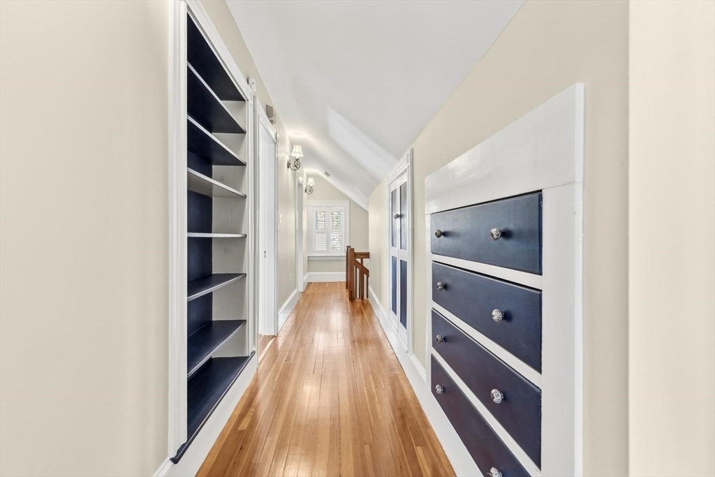 9 Governors Avenue, Unit 2 Winchester, MA 01890 - Photo 23 of 37 a view of a hallway with wooden floor and windows
