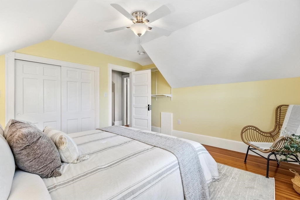 9 Governors Avenue, Unit 2 Winchester, MA 01890 - Photo 25 of 37 a bedroom with a bed a chair and a chandelier