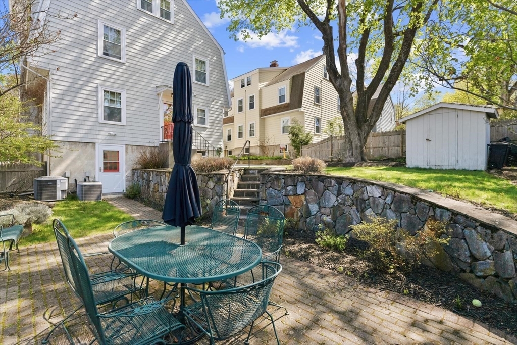 9 Governors Avenue, Unit 2 Winchester, MA 01890 - Photo 34 of 37 a backyard of a house with fountain table and chairs