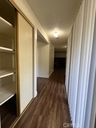 a view of a room with wooden floor and windows