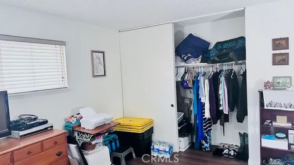 a bathroom with a granite countertop toilet sink and mirror