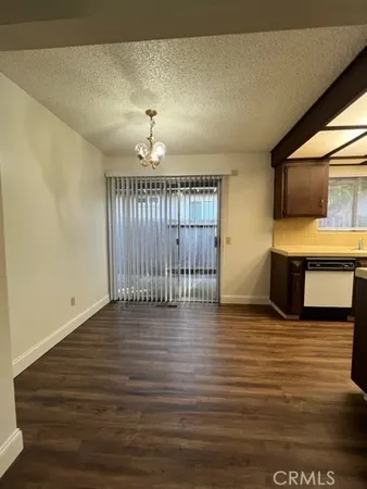 a kitchen with a sink dishwasher and a stove top oven