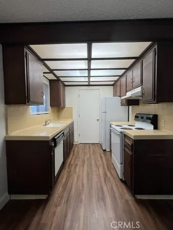 a kitchen with stainless steel appliances granite countertop a sink and a stove