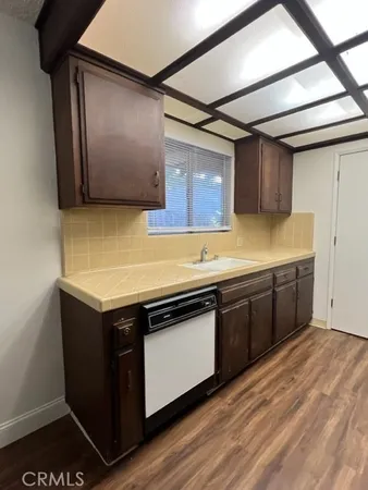 a view of a kitchen with wooden floor and a kitchen