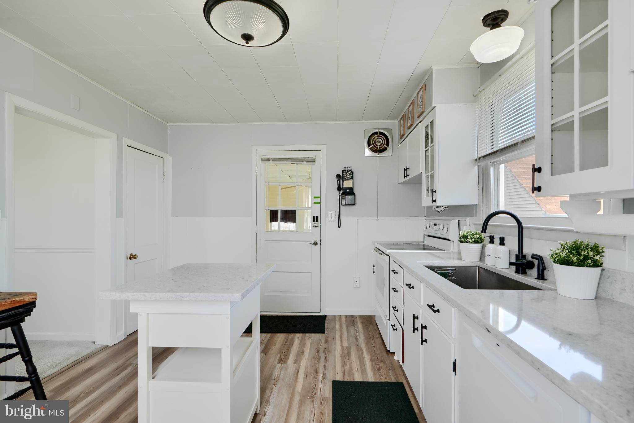 209 Middle River Road Baltimore, MD 21220 - Photo 13 of 35 a kitchen with white cabinets and sink