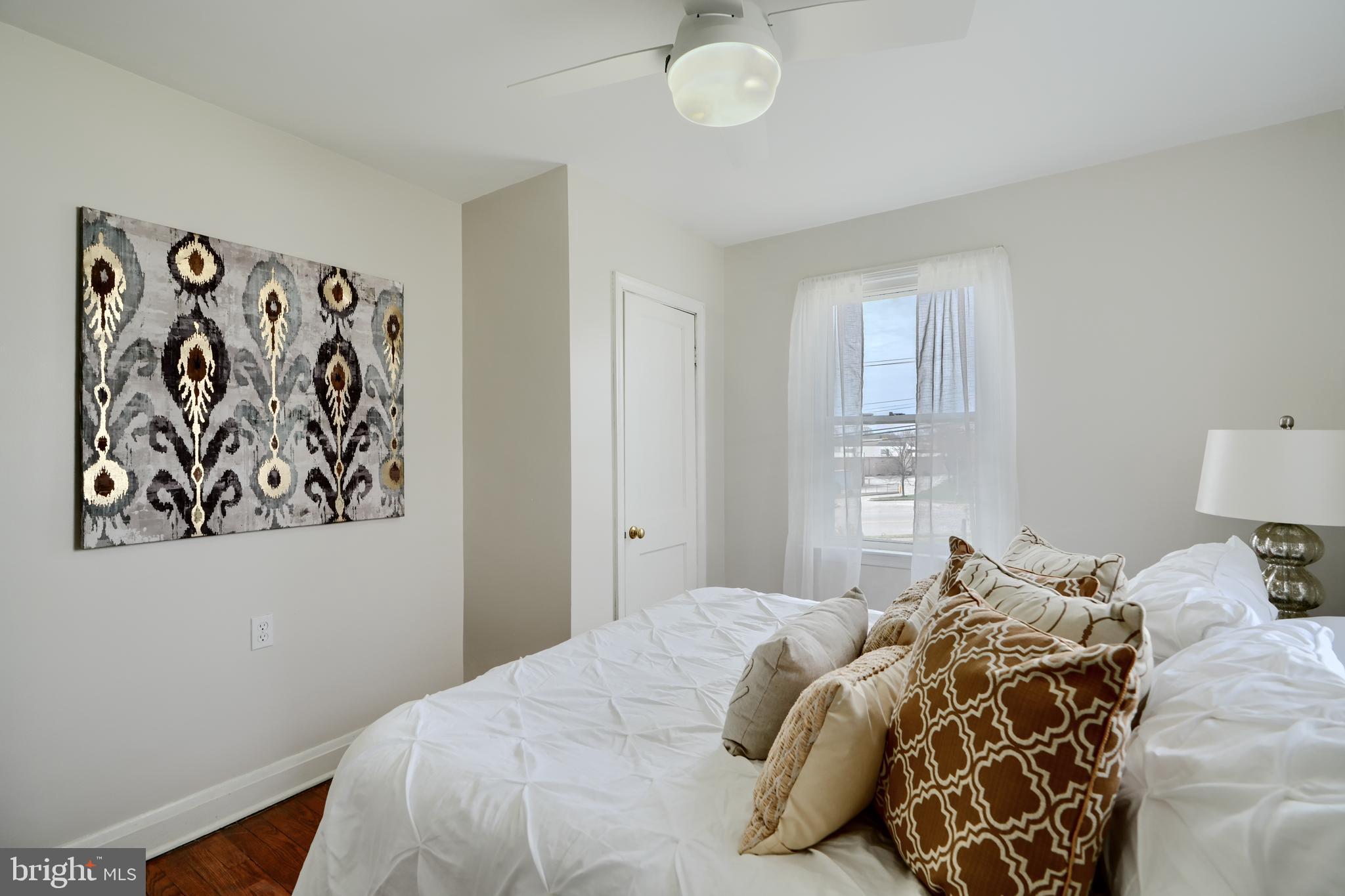 209 Middle River Road Baltimore, MD 21220 - Photo 17 of 35 a bedroom with a bed and a painting on the wall