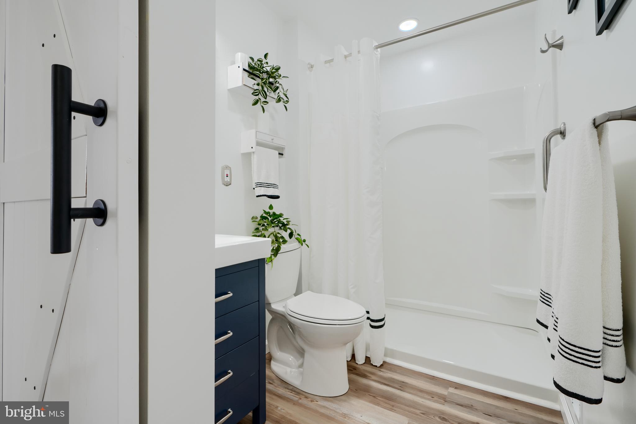 209 Middle River Road Baltimore, MD 21220 - Photo 19 of 35 a bathroom with a shower a toilet and a sink