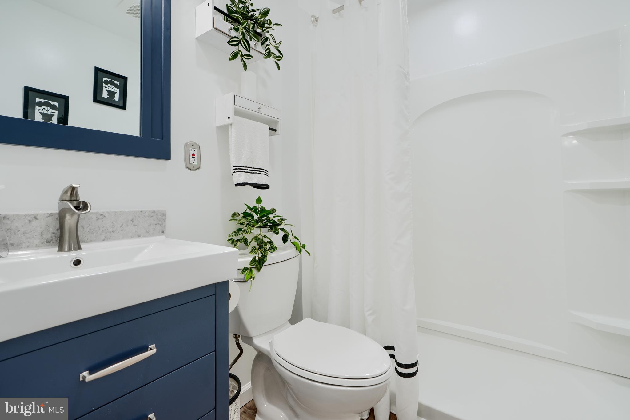 209 Middle River Road Baltimore, MD 21220 - Photo 20 of 35 a bathroom with a sink a toilet and mirror