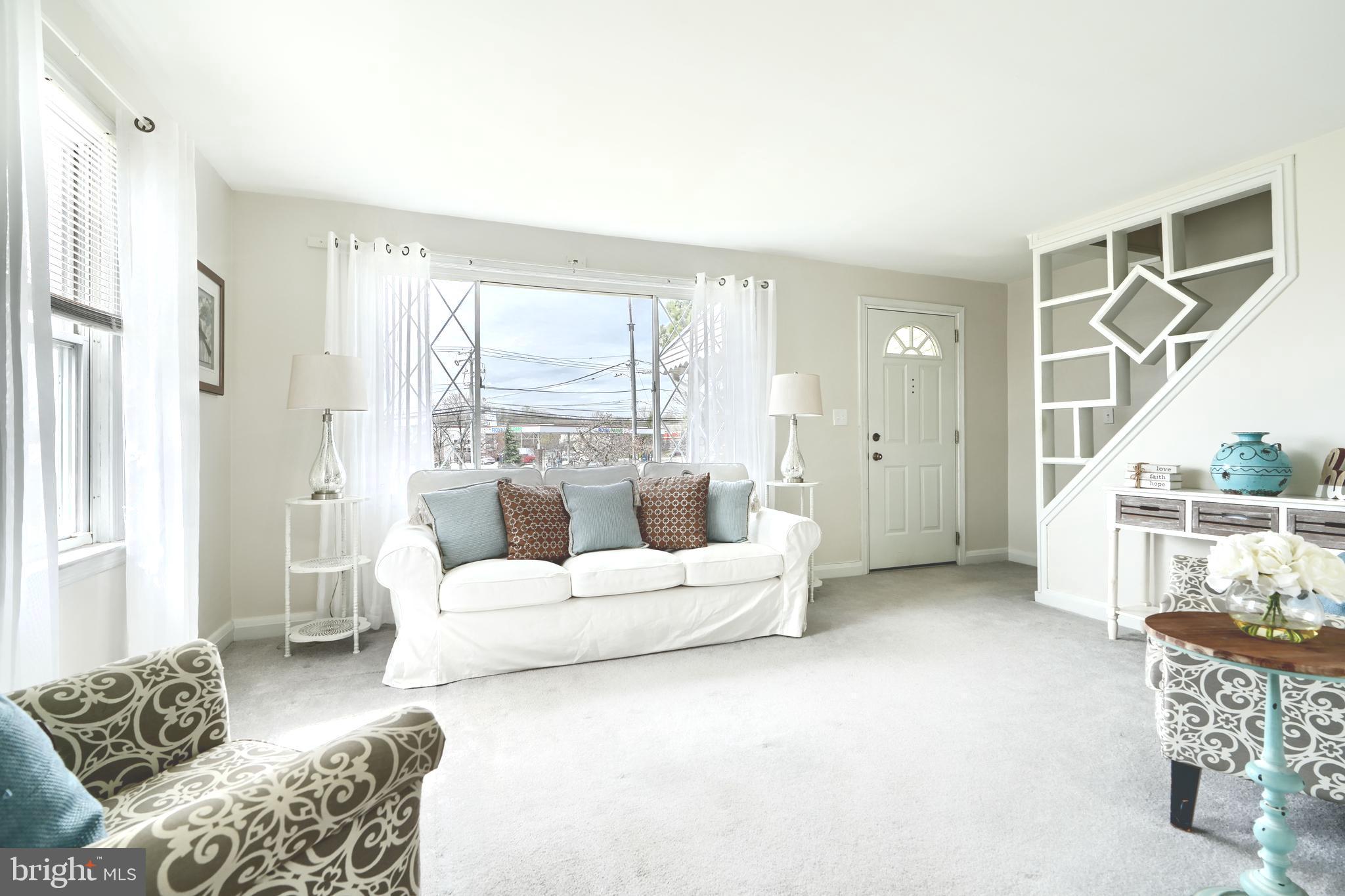 209 Middle River Road Baltimore, MD 21220 - Photo 2 of 35 a living room with furniture and a large window