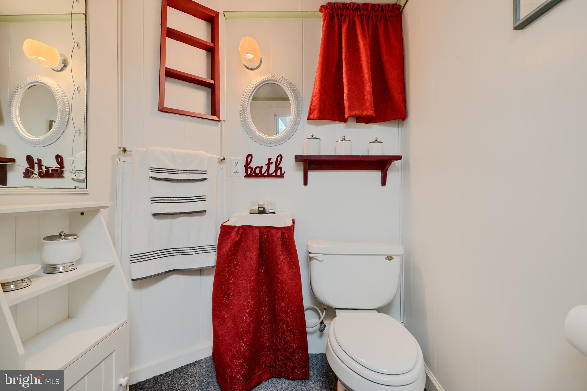 209 Middle River Road Baltimore, MD 21220 - Photo 29 of 35 a bathroom with a toilet a sink and a shower curtain