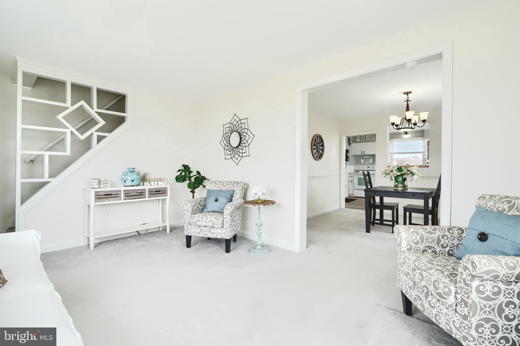 209 Middle River Road Baltimore, MD 21220 - Photo 4 of 35 a living room with furniture and a dining table with kitchen view