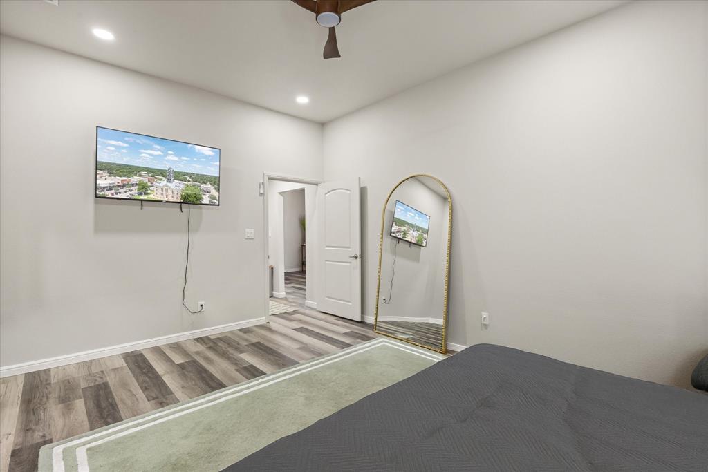 4801 West Wedgefield Road Granbury, TX 76049 - Photo 19 of 40 a view of a room with bed and mirror