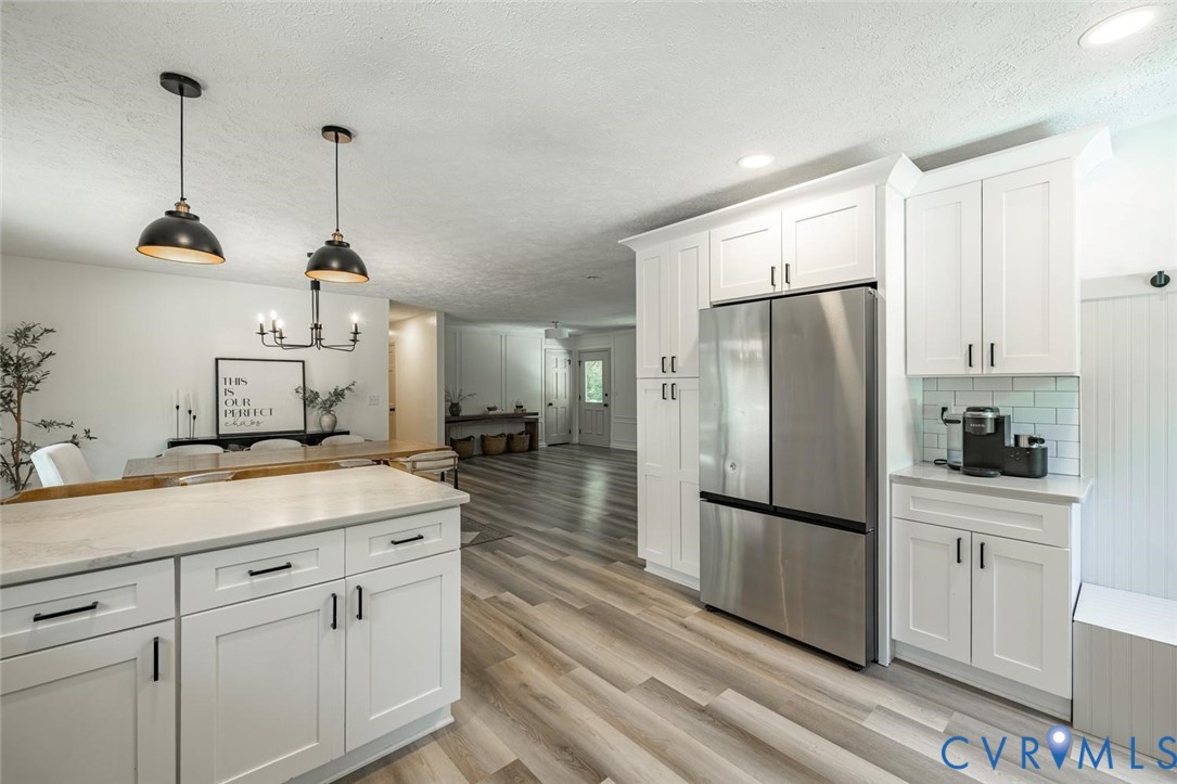 12397 New Market Mill Road Beaverdam, VA 23015 - Photo 9 of 44 a kitchen with a refrigerator a sink and cabinets