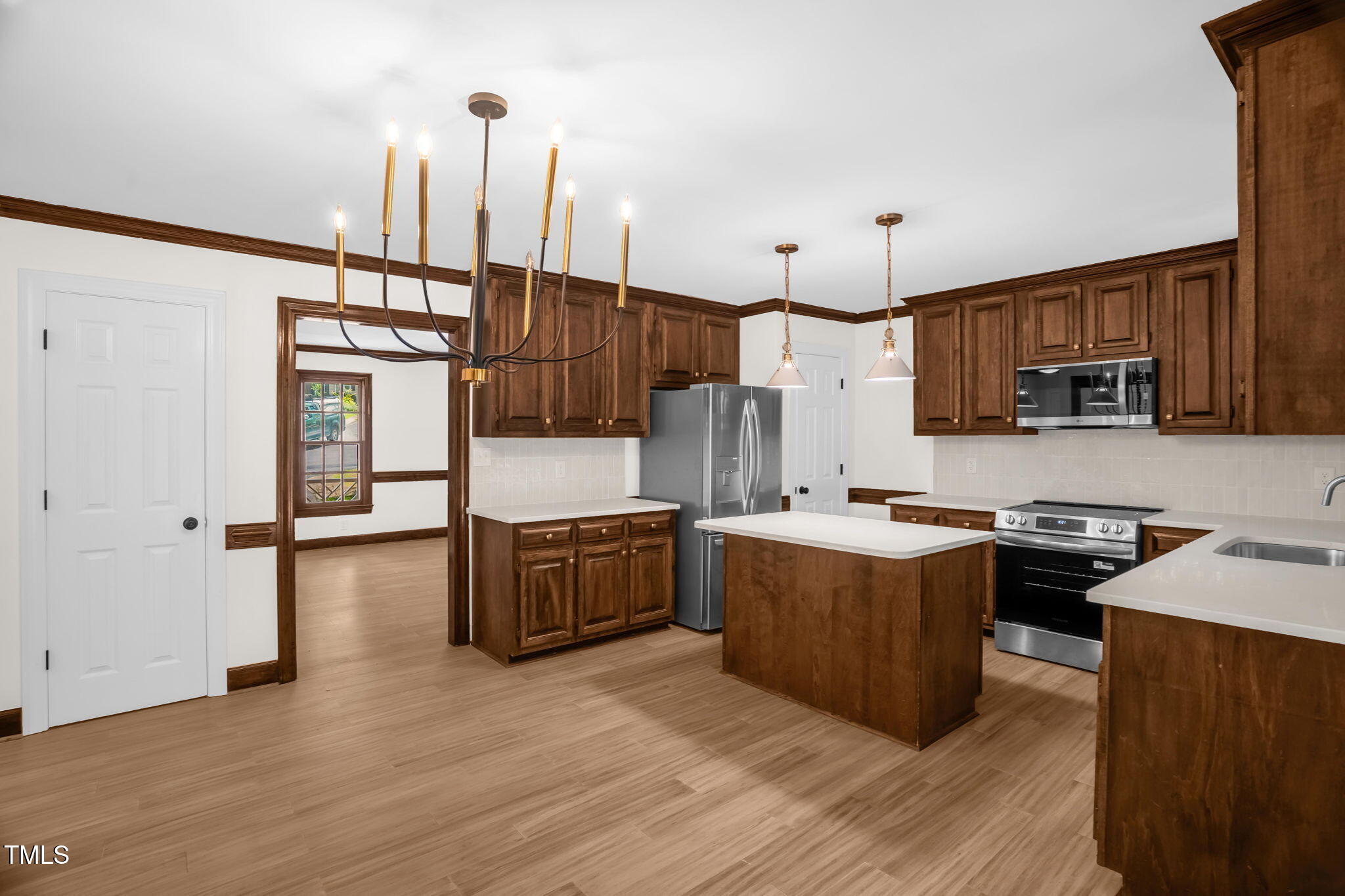 616 Cross Timbers Drive Durham, NC 27713 - Photo 12 of 29 a kitchen with stainless steel appliances granite countertop a stove top oven a sink dishwasher a refrigerator and a dining table with wooden floor