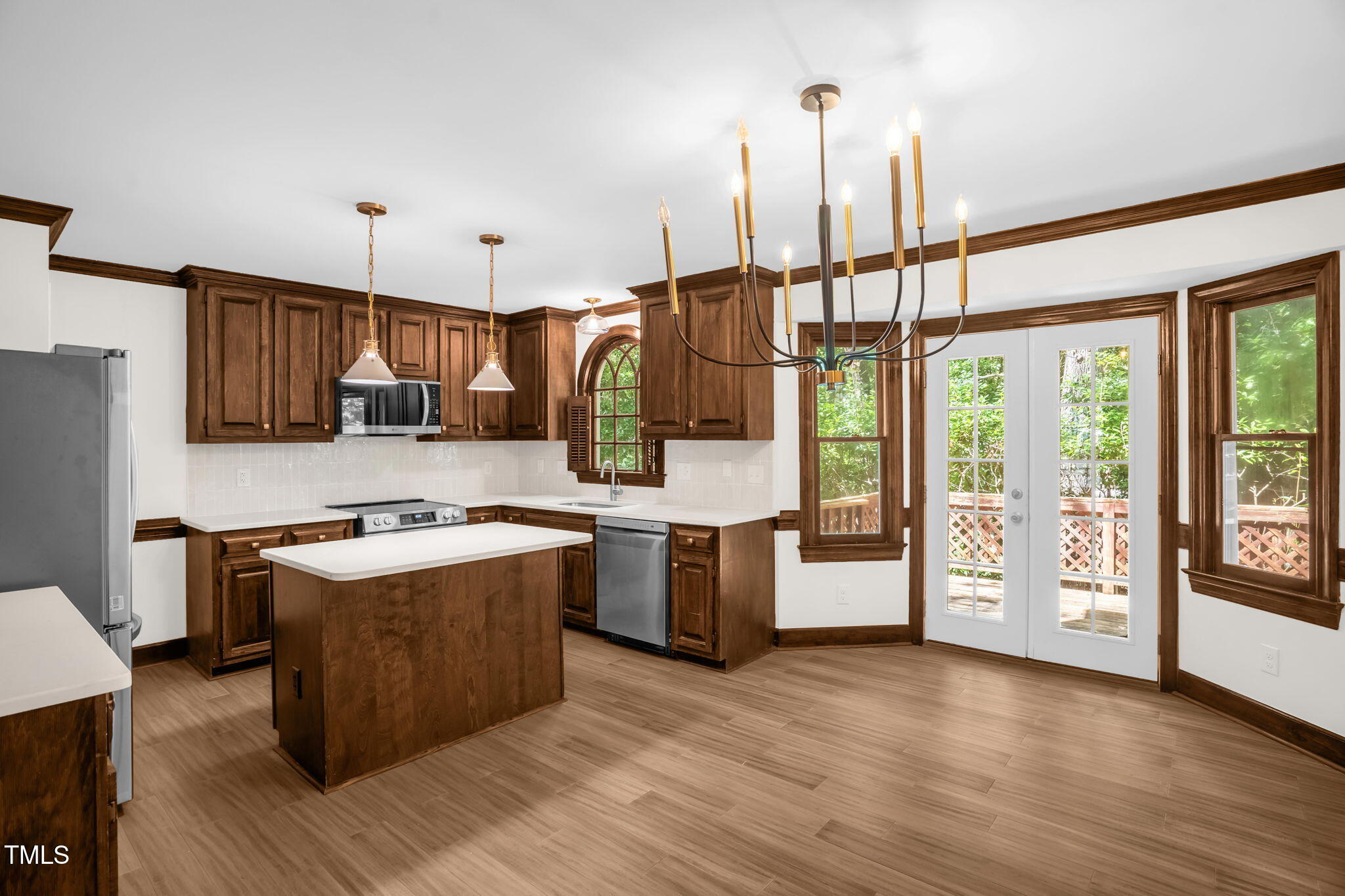 616 Cross Timbers Drive Durham, NC 27713 - Photo 13 of 29 a kitchen with stainless steel appliances granite countertop a stove a refrigerator a sink and a wooden floors