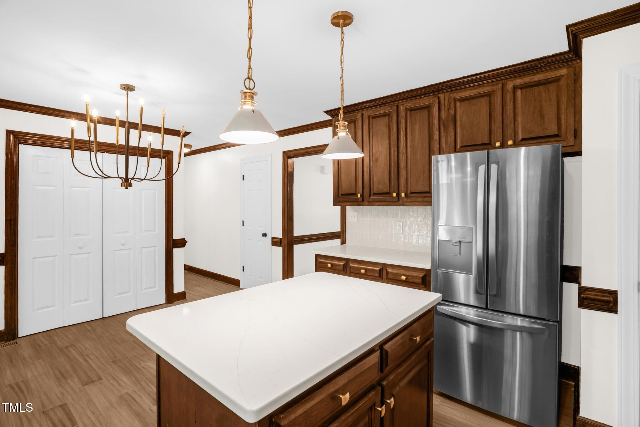 616 Cross Timbers Drive Durham, NC 27713 - Photo 16 of 29 a kitchen with stainless steel appliances a refrigerator and wooden floor