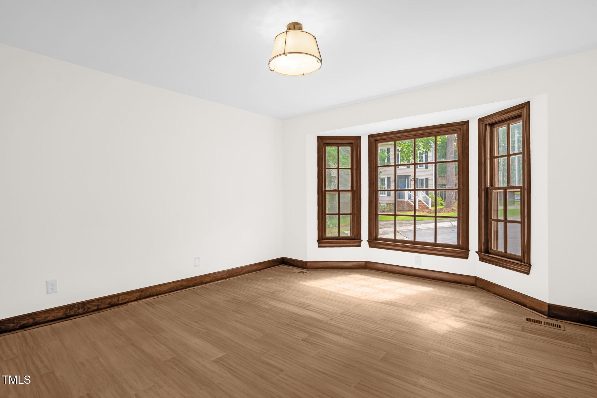 616 Cross Timbers Drive Durham, NC 27713 - Photo 20 of 29 a view of an empty room with wooden floor and a window