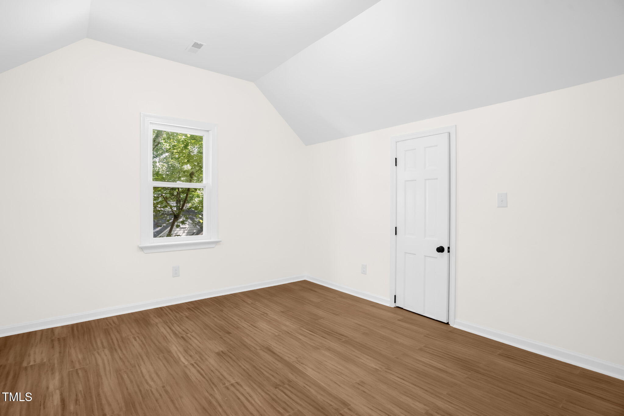 616 Cross Timbers Drive Durham, NC 27713 - Photo 25 of 29 a view of an empty room with wooden floor and a window