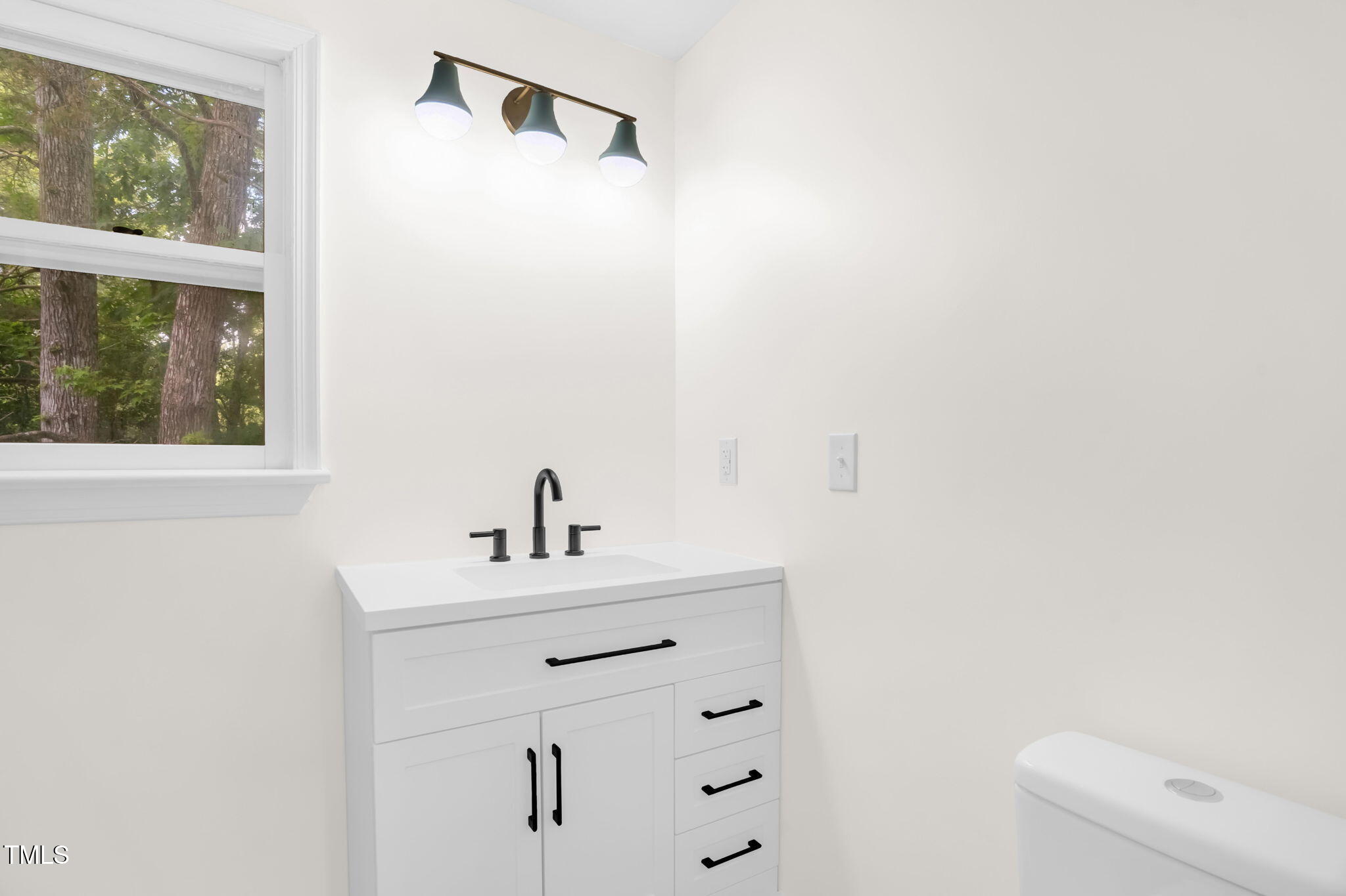 616 Cross Timbers Drive Durham, NC 27713 - Photo 27 of 29 a bathroom with a sink a toilet and a window